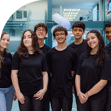 Group of smiling young people wearing black t-shirts.
